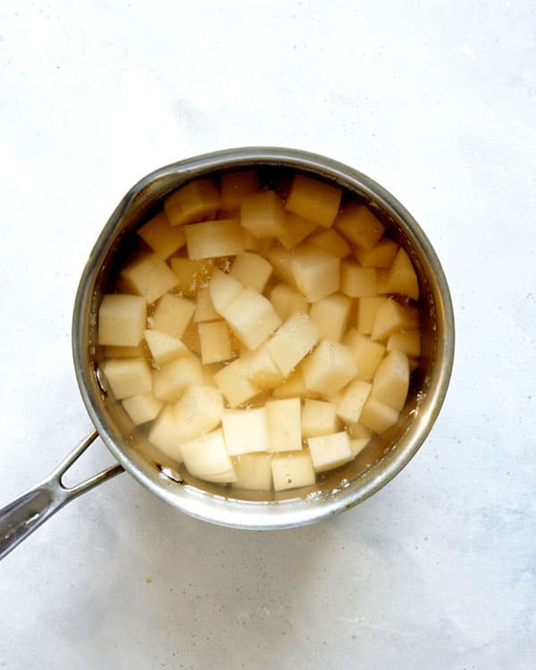 Potatoes being boiled in a pot.
