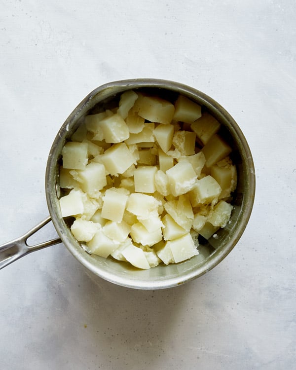 Cooked potatoes in a pot to make Colcannon.