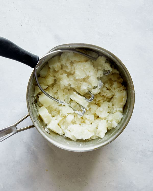 Mashed potatoes in a pot to make Browned Butter Colcannon.