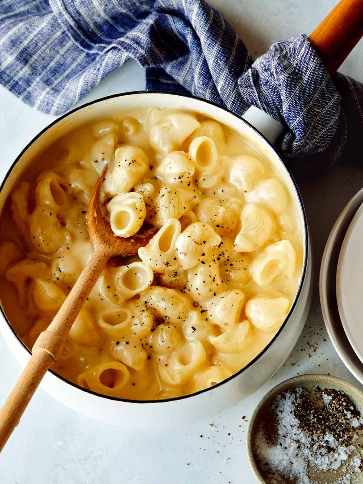 Stovetop mac and cheese in a pot with a spoon in it. 