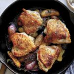 Crispy chicken thigh recipe in a skillet.