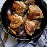 Crispy chicken thigh recipe in a skillet.