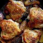 Crispy chicken thigh recipe in a skillet.