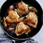 Crispy chicken thigh recipe in a skillet.