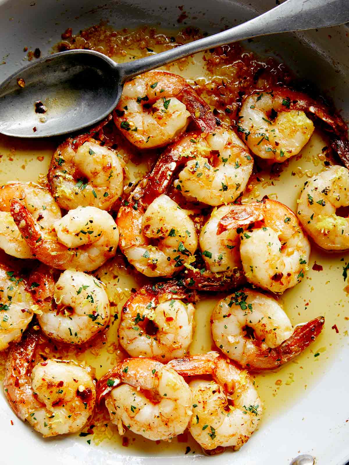 Close up on a skillet of Shrimp Scampi. 