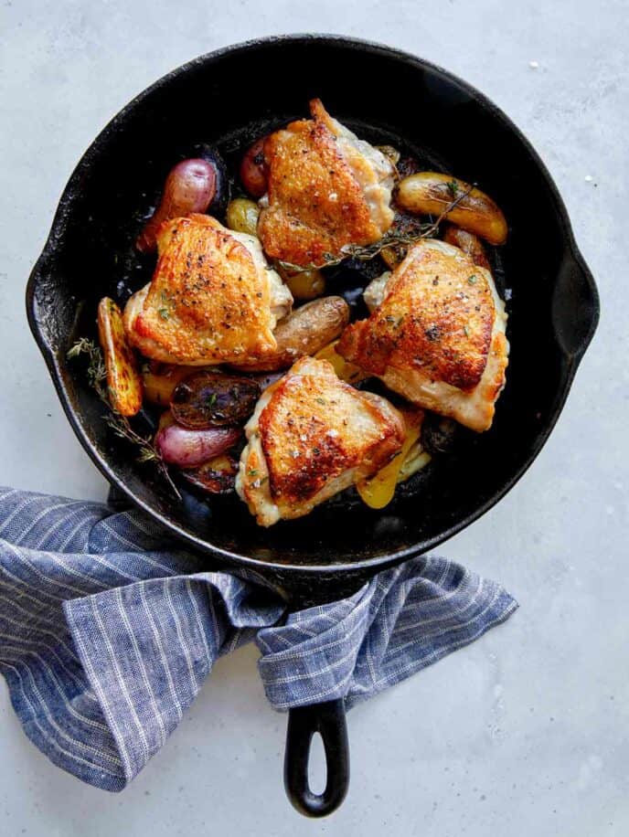 Crispy chicken thigh recipe in a skillet.