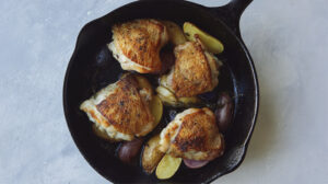 Crispy chicken thigh recipe in a skillet.