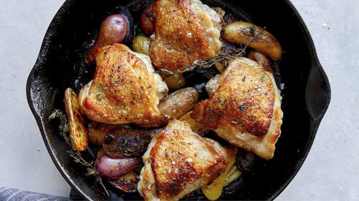 Crispy chicken thigh recipe in a skillet.