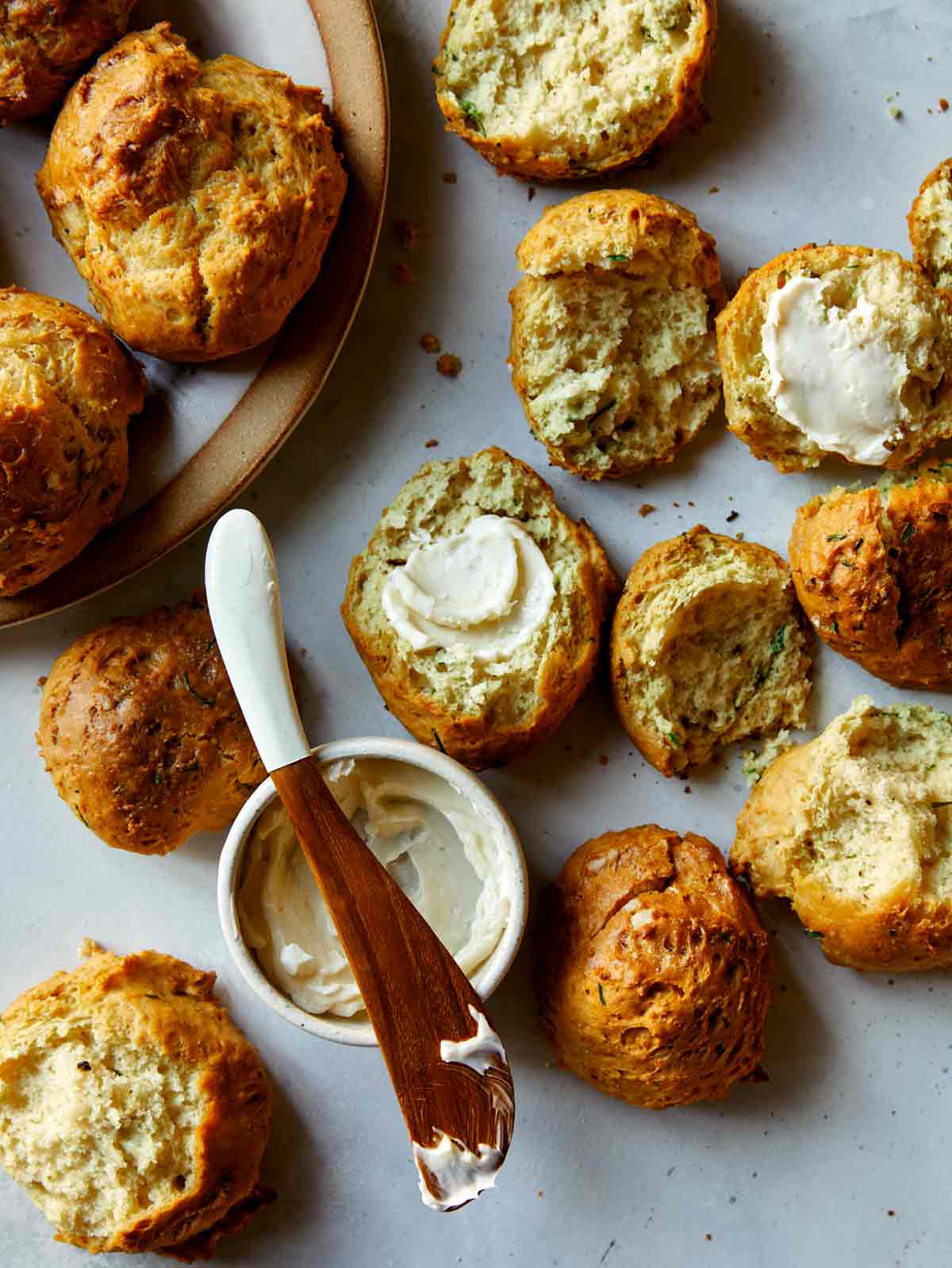 Sour cream and chive drop biscuits with some open served with butter. 