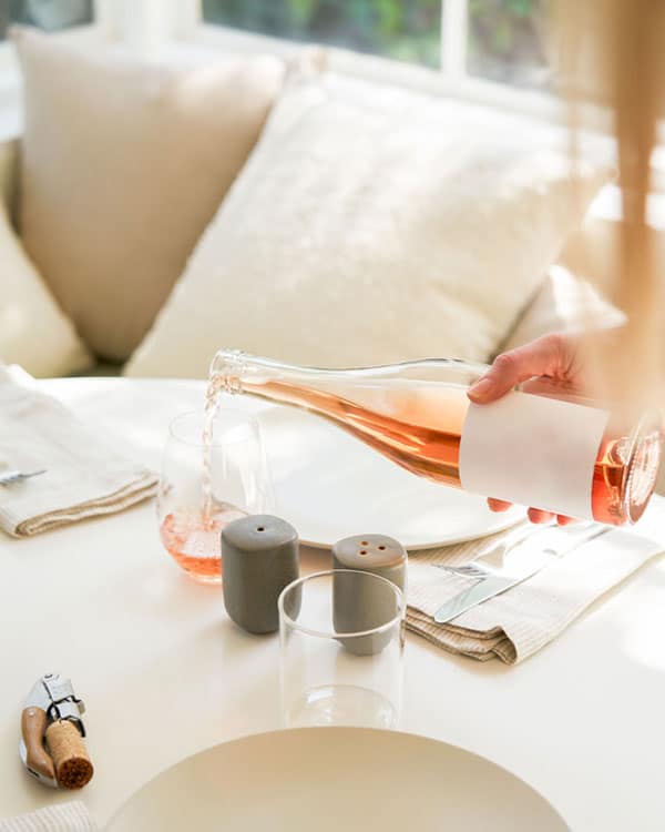 An image of a lady pouring wine.