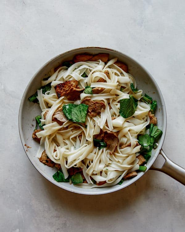 Noodles with broccoli and pork for pad see ew. 