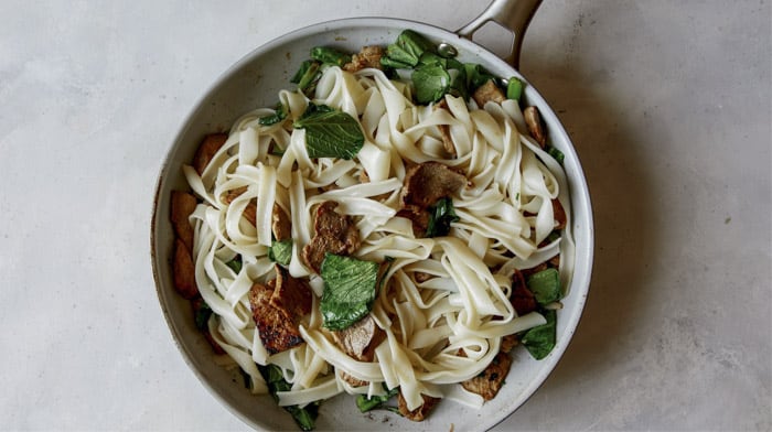 Noodles with broccoli and pork for pad see ew.