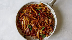 Pork pad see ew in a skillet.