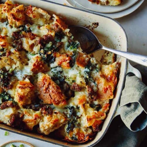 Sausage strata recipe in a dish with a scoop out.