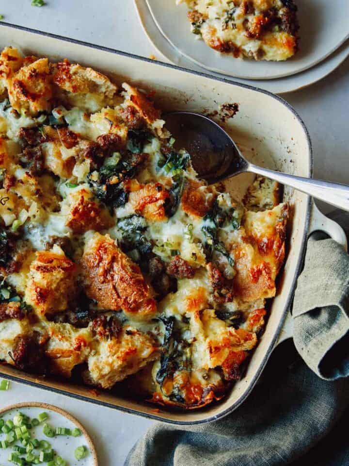 Sausage strata recipe in a dish with a scoop out.