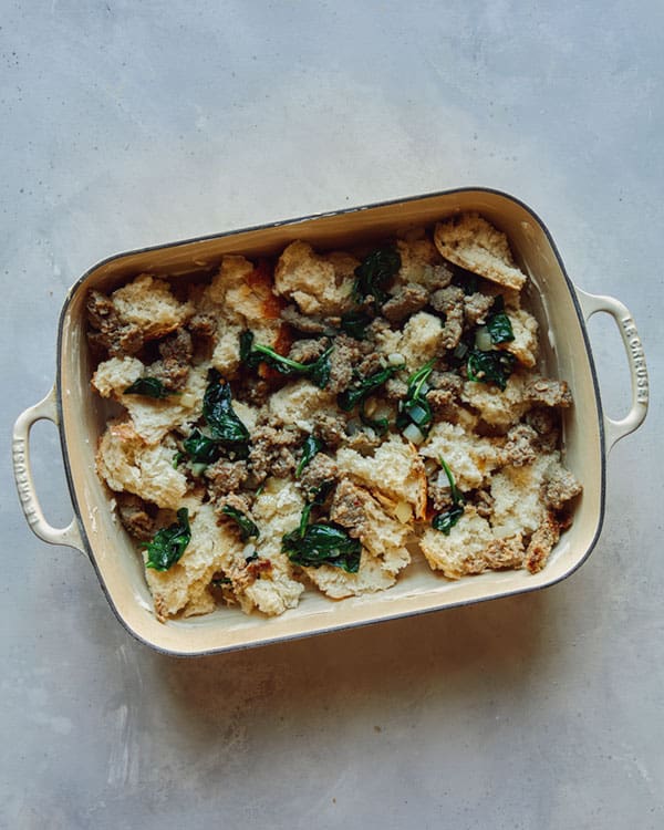Process of layering the sausage strata recipe in a baking dish.