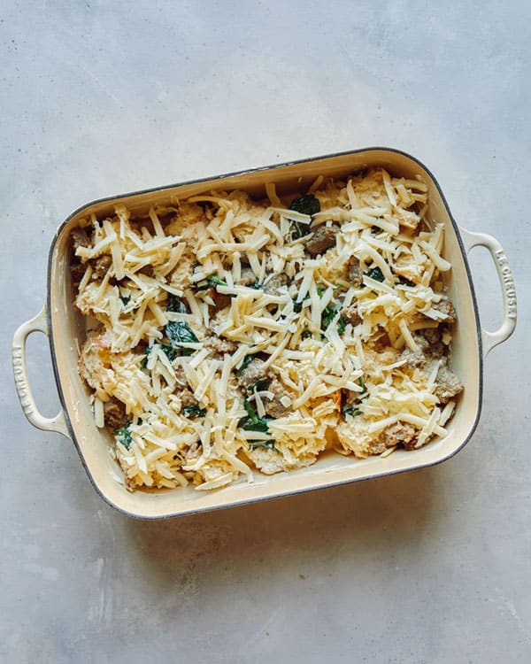 Process of layering the sausage strata recipe in a baking dish.