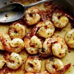 Close up on a skillet of Shrimp Scampi.