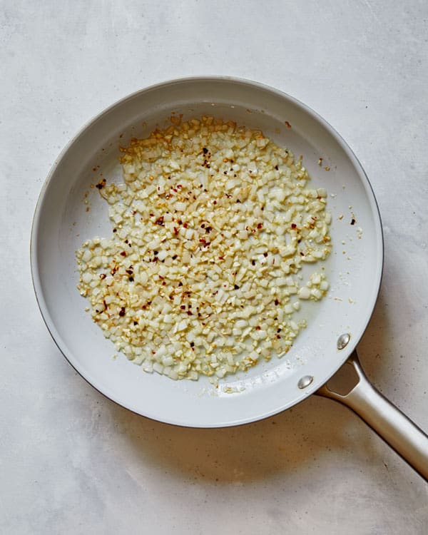 Shallots and garlic cooking with oil and butter.