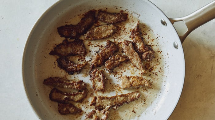 Cooking beef in a skillet.