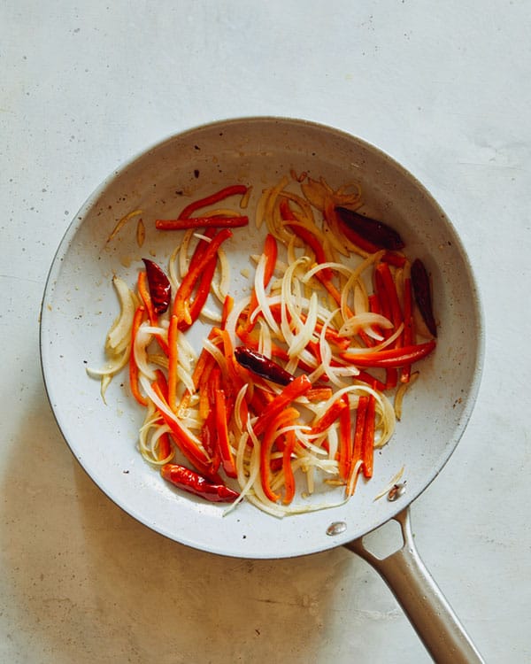 Cooking peppers and chiles in a skillet.