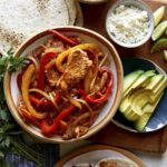 Chicken fajita recipe with toppings on the side.