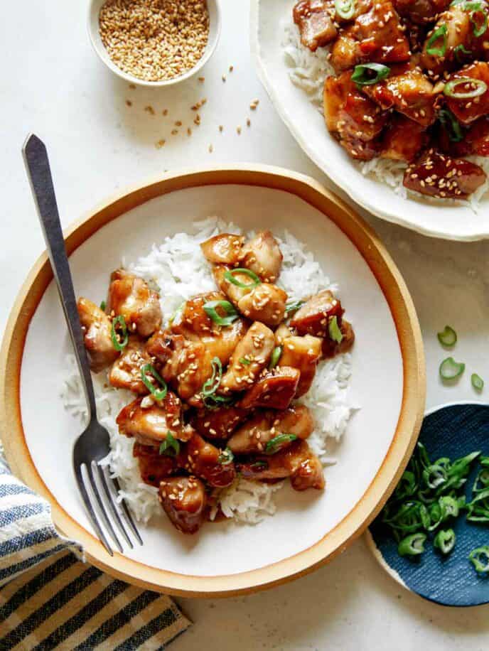 Honey garlic chicken dinner recipe with sesame seeds and green onions.