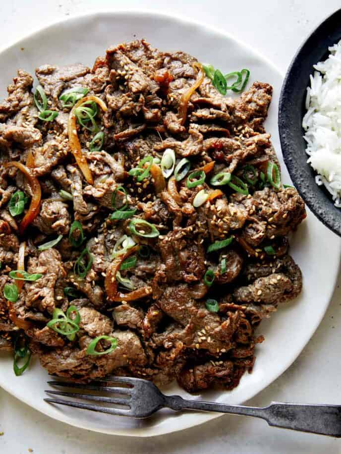 Beef bulgogi recipe on a plate with rice. 
