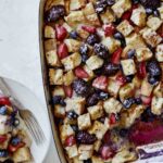 Berry bread pudding recipe being served onto plates.