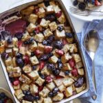 Berry bread pudding recipe being served onto plates.