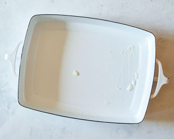 Grease a baking dish for berry bread pudding.