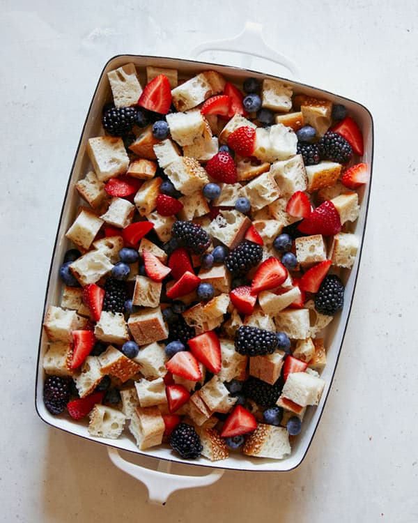 Bread pudding with berries in a baking dish.