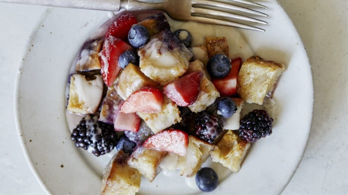 Triple berry bread pudding recipe on a plate.