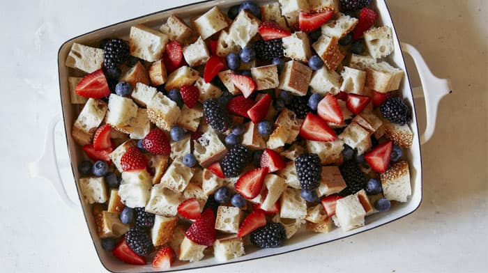 Bread pudding with berries in a baking dish.