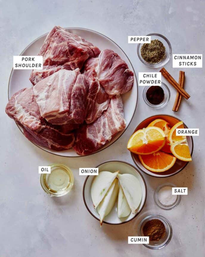 Carnitas ingredients on a kitchen counter. 