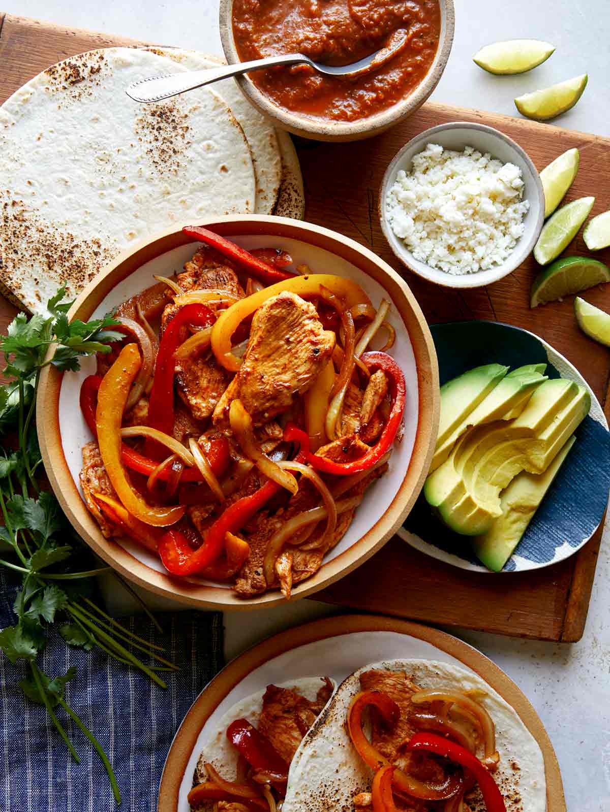 Chicken fajita recipe with toppings on the side. 