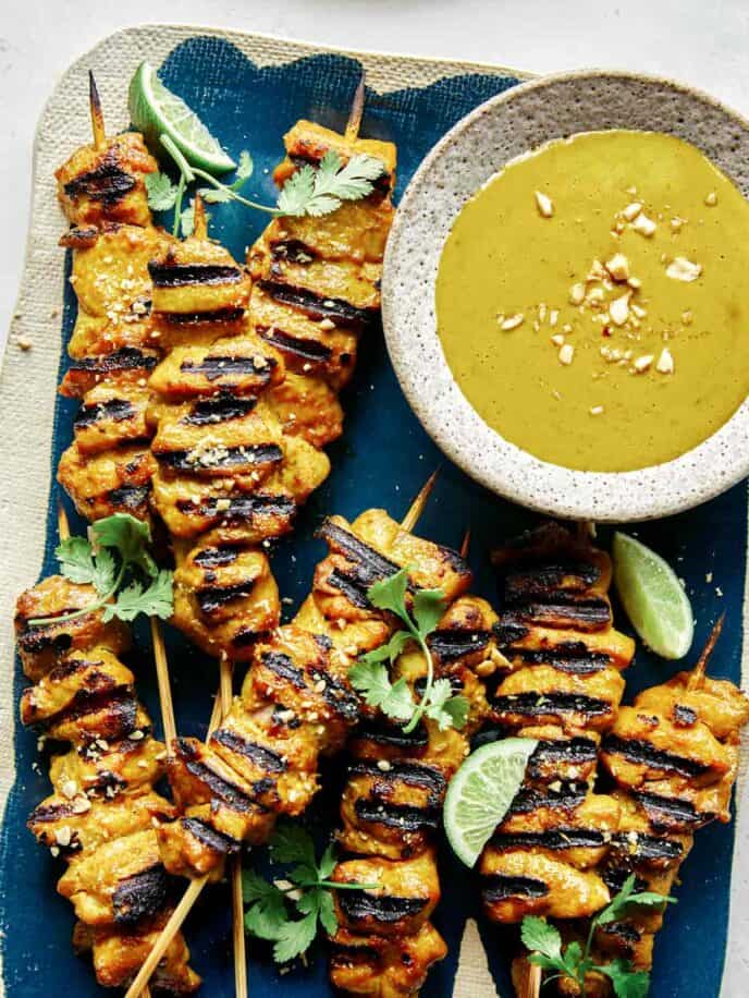 Chicken satay on a platter with lime wedges for Fathers day dinner. 