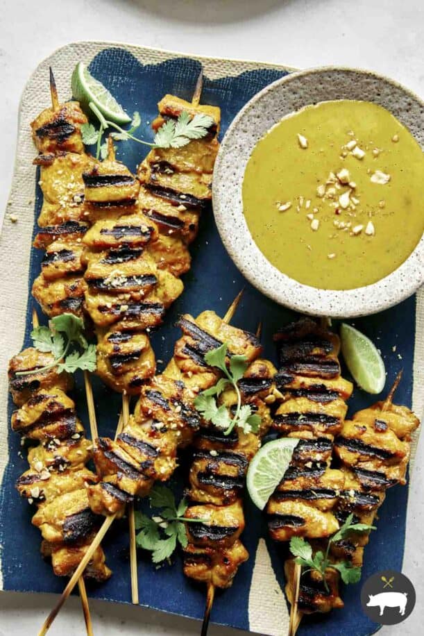 Chicken satay recipe being served onto plates.