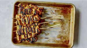 Cooked skewers grilled resting on a platter.