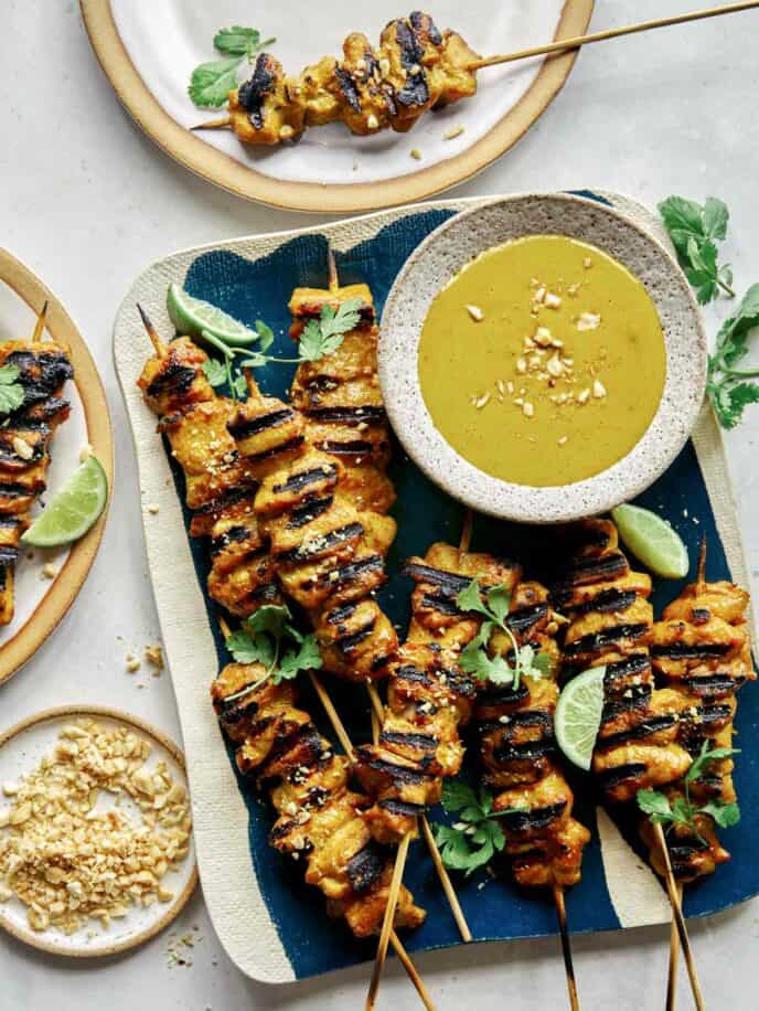 Chicken satay recipe with some plated on the side.