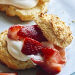 Close up on a strawberry shortcake with whipped cream.