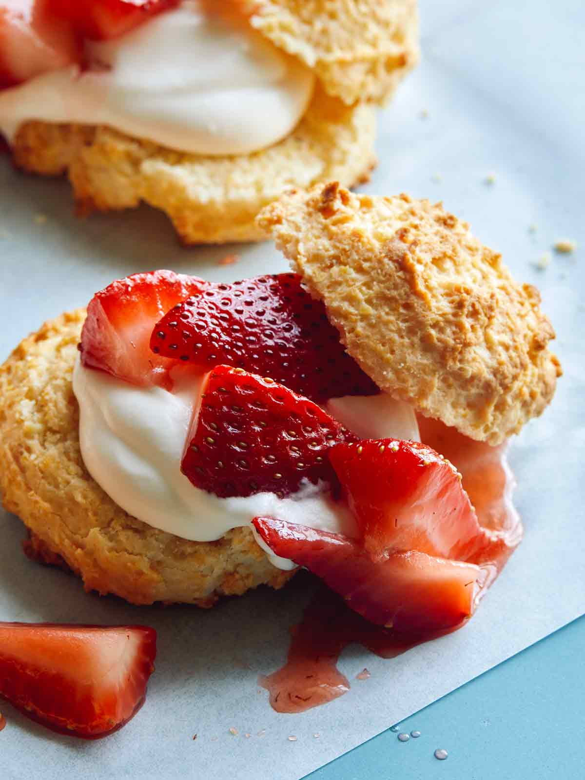 Close up on a strawberry shortcake with whipped cream.