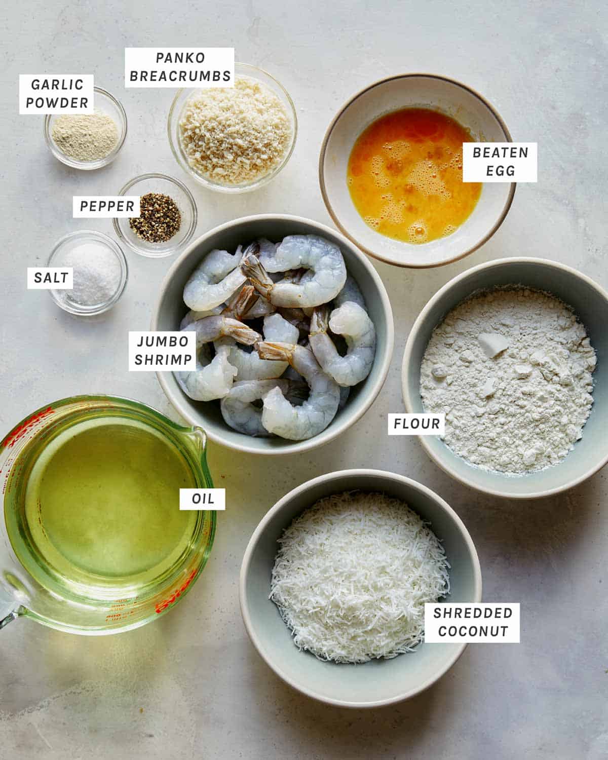 Coconut shrimp ingredients on a kitchen counter.
