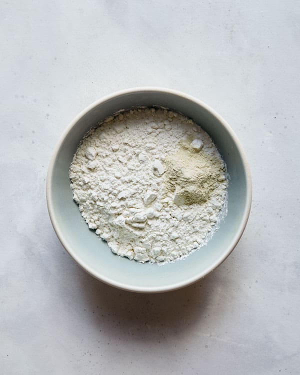 Flour and garlic powder in a bowl for coconut shrimp. 