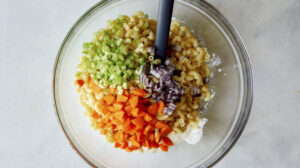 Hawaiian style macaroni salad ingredients in a bowl.
