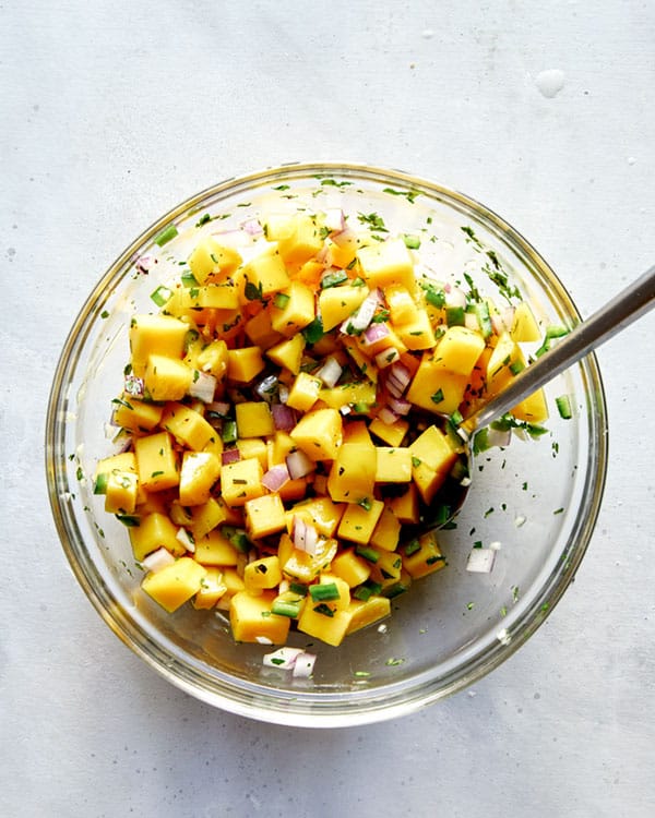 Mango salsa ingredients in a bowl mixed together.