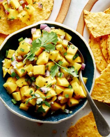Mango salsa in a bowl with chips.