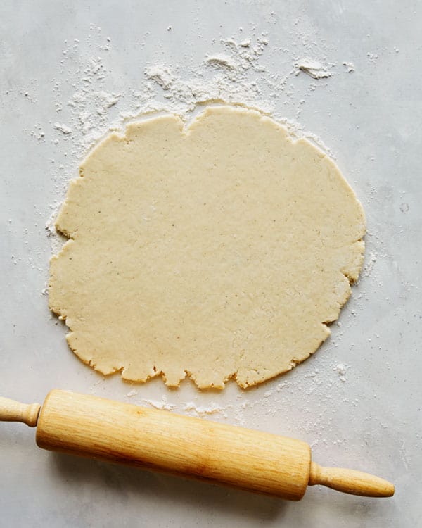 Old fashioned donut dough being rolled out.
