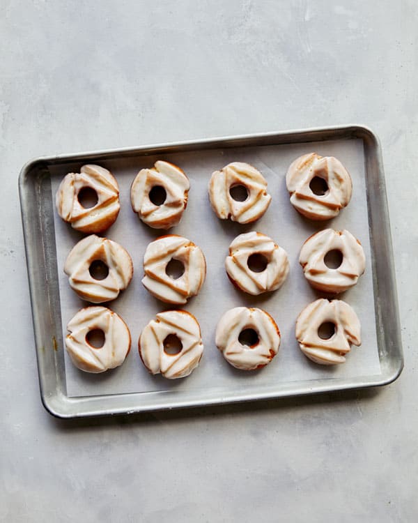 A tray of old fashioned donuts freshly glazed.