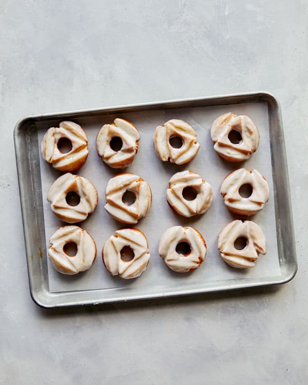 A tray of old fashioned donuts freshly glazed. 